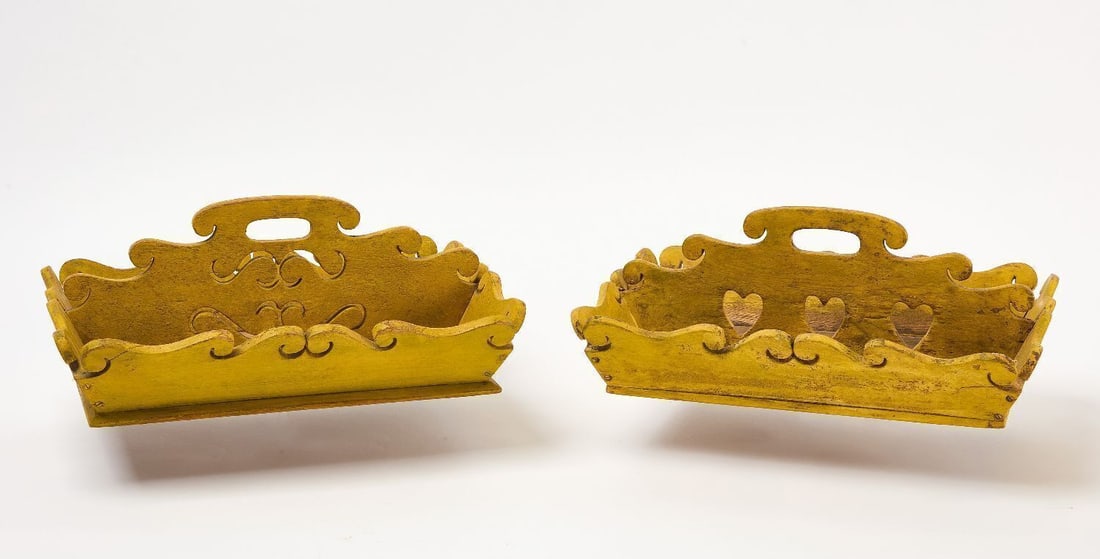 Two Knife Carriers in Yellow Paint: Two knife carriers/boxes in yellow paint. One with inner openwork hearts carved. Flathead construction with canted sides. American, late 19th cenutry. Later paint.(Each): H 5-1/4 in. W 13-1/2 in. D 10