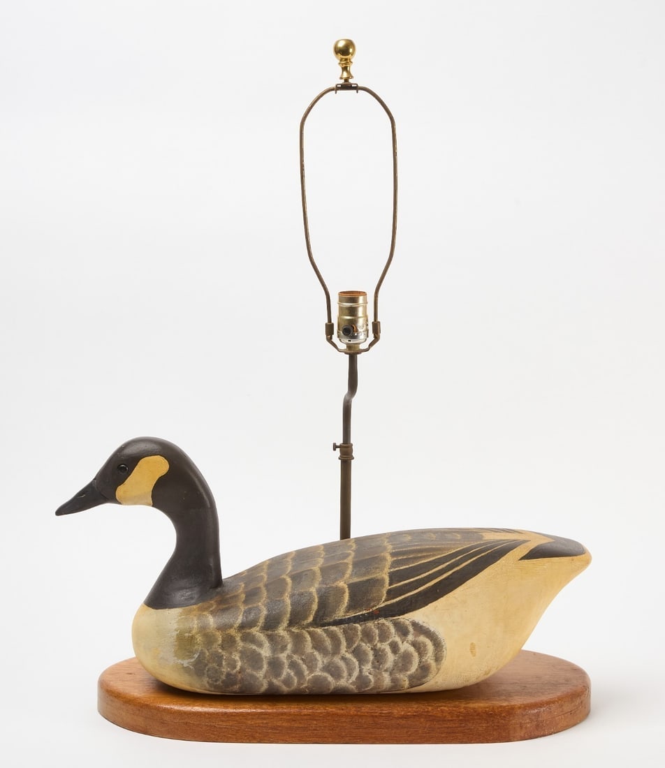 Carved Goose Decoy Lamp: Goose decoy lamp. Carved wood with original paint. Mahogany base. American, circa 1940. H (to top of goose head)13-1/4 in. L 22-1/2 in. 