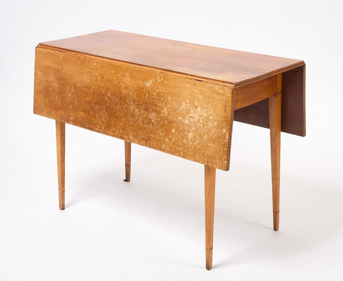 Hepplewhite Drop Leaf Table: Hepplewhite drop leaf table with line inlaid frieze and four tapered square legs. American, early 19th century.Closed: H 28-1/2 in. W 41-1/4 in. D 18-5/8 in. Open: H 28-1/2 in. W 41-1/4 in.