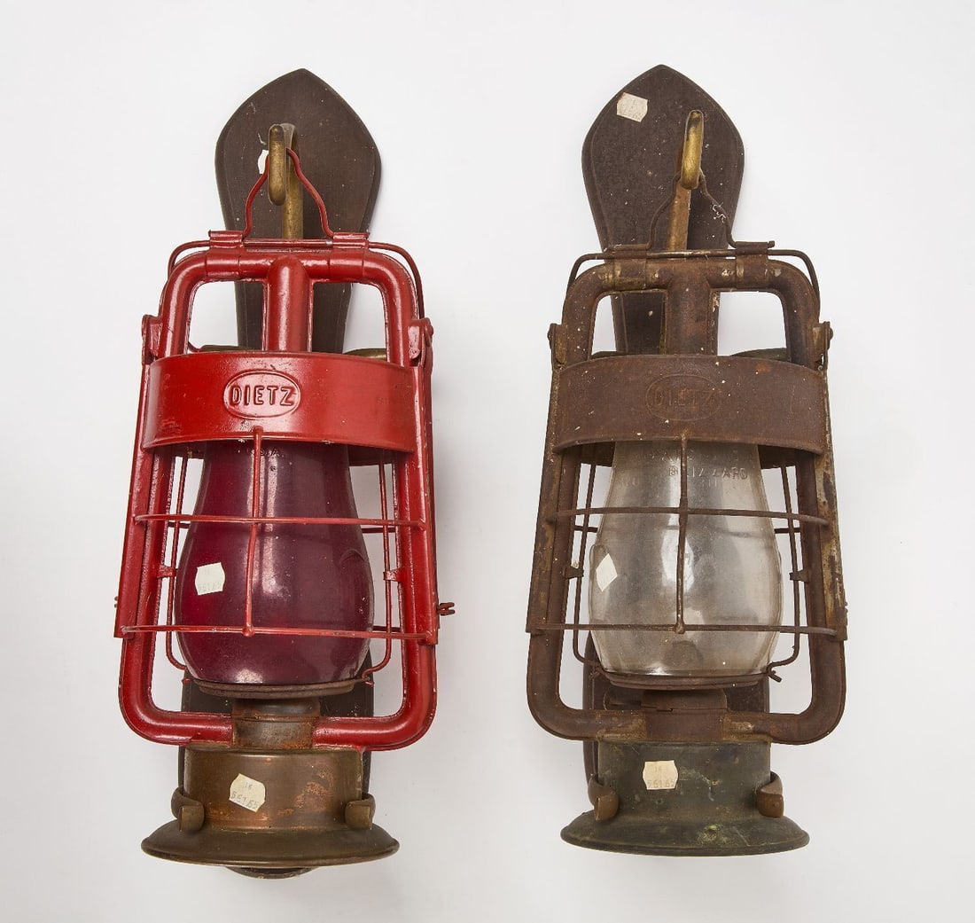 Two Dietz Fire Dept. Kerosene Lanterns: Two fire department kersone lanters. One with clear globe, the other with a red globe. clear R.E. Dietz Company maker's mark to both. Tinned steel and brass outer structure, mounted to carved wood