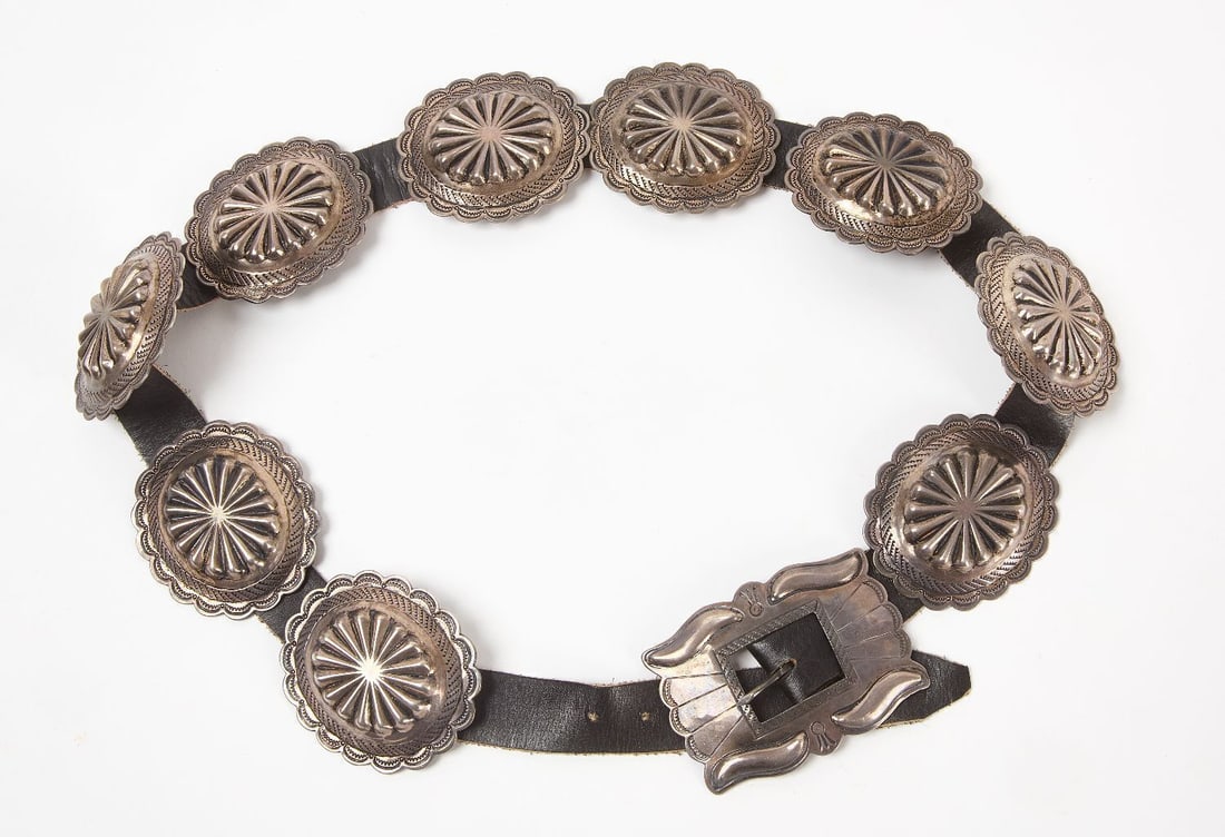 Navajo Silver Concho Belt: Navajo silver concho belt. Hammered silver. Southwestern US, mid 20th century. Overall: L 39-3/4 in. Conchos: L 2-1/2 in. W 2-3/4 in. Approx silver weight (excl. belt): 10 ozt.