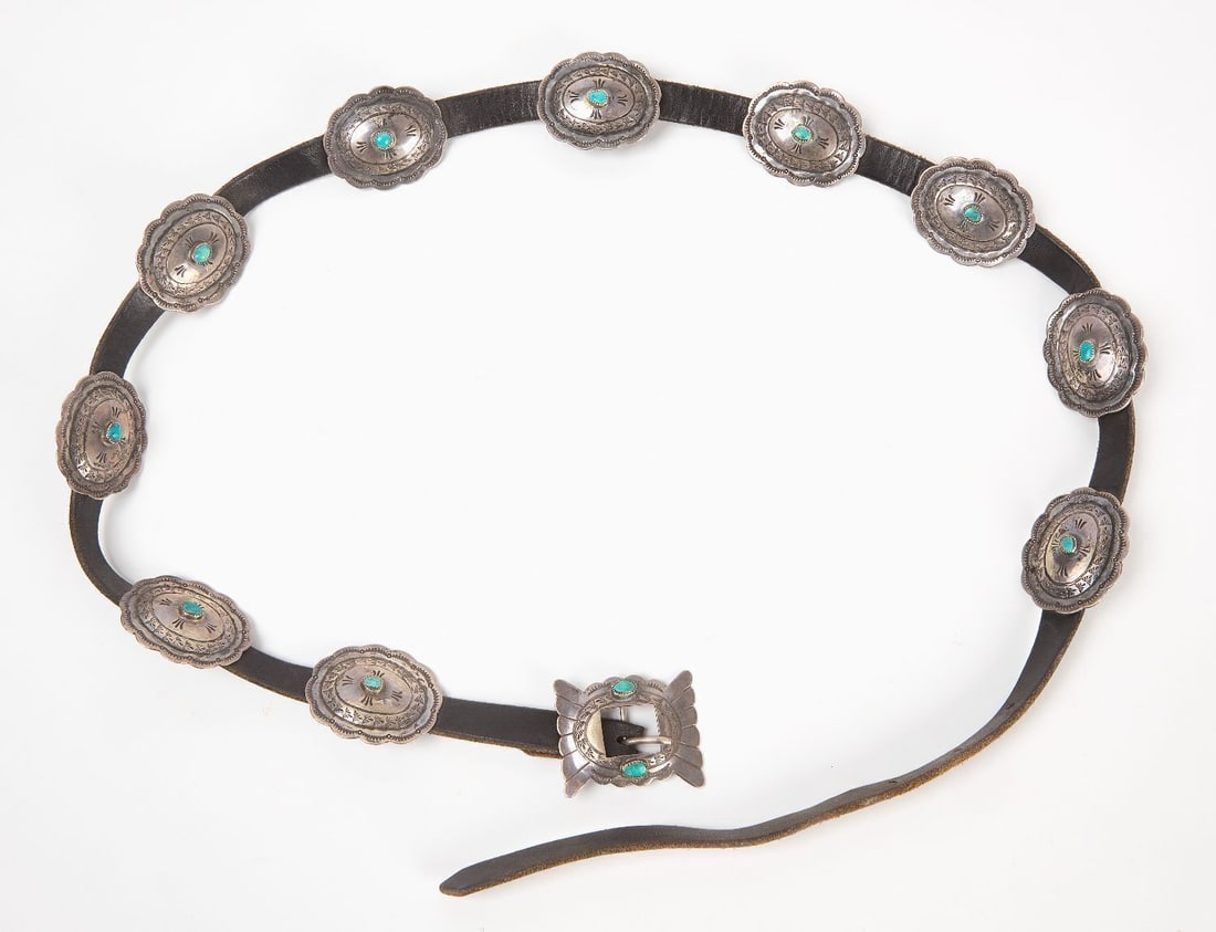 Navajo Concho Belt: Navajo concho belt. Hammered silver with likely original leather belt. Southwestern US, mid 20th century. L 52 in. Concho: L 1-3/4 in. W 2-1/8 in. Total Weight (incl. belt): 8.66 ozt.