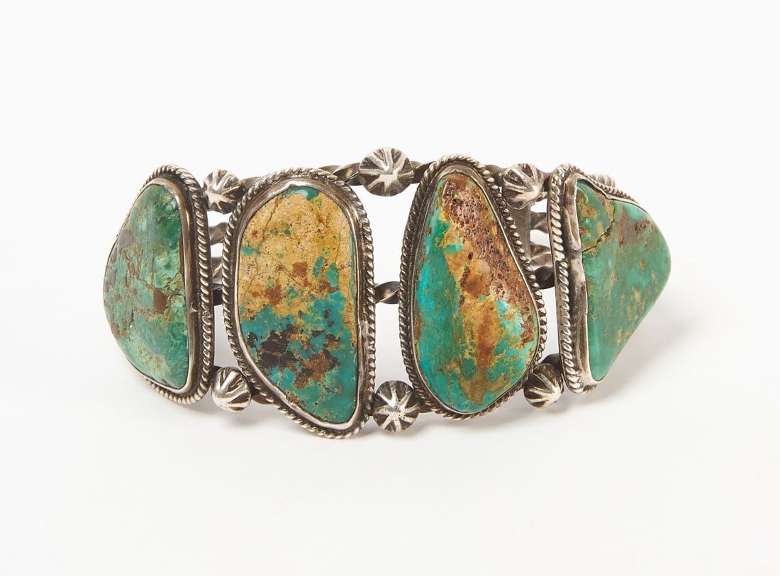 Native American Turquoise Cuff Bracelet: Native American turquoise and silver cuff bracelet. Four large natural green turquoise stones inset on 3 twisted silver bands. Southwestern US, 20th century. Total Weight: 2.5 ozt. Outer W: 3-1/4