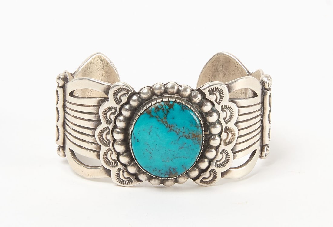 G. Ramone Sterling Silver Native Cuff Bracelet: G. Ramone (signed) sterling silver cuff bracelet with single inset round turquoise cabochon. Southwestern US, 20th century. Total Weight: 3 ozt. Outer W: 2-3/4 in., Inner W: 2-1/2 in. 