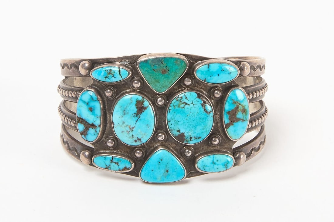 Navajo Four-Strand Silver Cuff: Navajo four-strand silver cuff bracelet. Features two different types of turquoise. Southwestern US, 20th century. Total Weight: 2.375 ozt. Outer W: 2-5/8 in. Inner W: 2-1/2 in.
