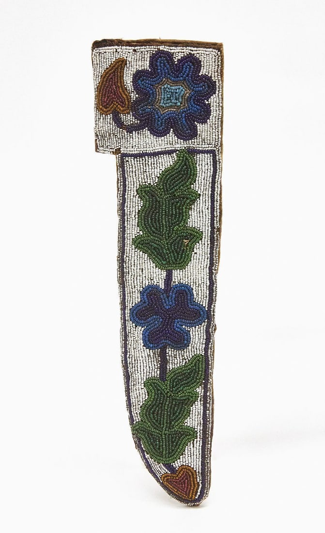 Native American Ojibwa Knife Sheath: Ojibwa knife sheath. Beadwork on buckskin. Sinew sewn. Floral pattern shows woodland influence on adjacent Plains culture. Upper Missouri River region, circa 1870. L 11 in. W 3 in.
