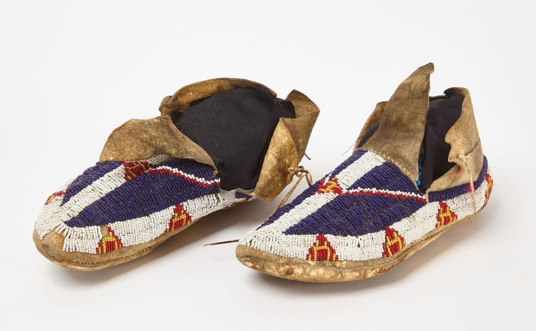 Pair of Native Beaded Moccisans: Pair of Native moccasins. Beadwork on hide. Sinew sewn. Plains region. circa 1900. L 10-1/2 in.