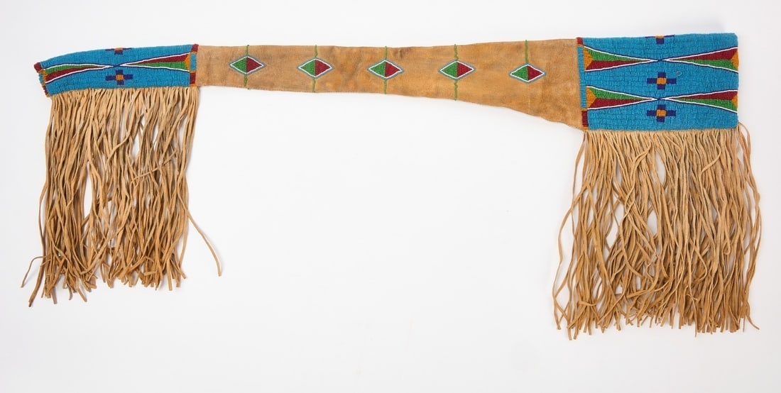 Native Beaded Scabbard: Native scabbard with. fringe. Glass beads on hide with cloth lining. Sinew sewn. Plains region, circa 1915. L 43-1/4 in. W (without fringe) 6-1/8 in.