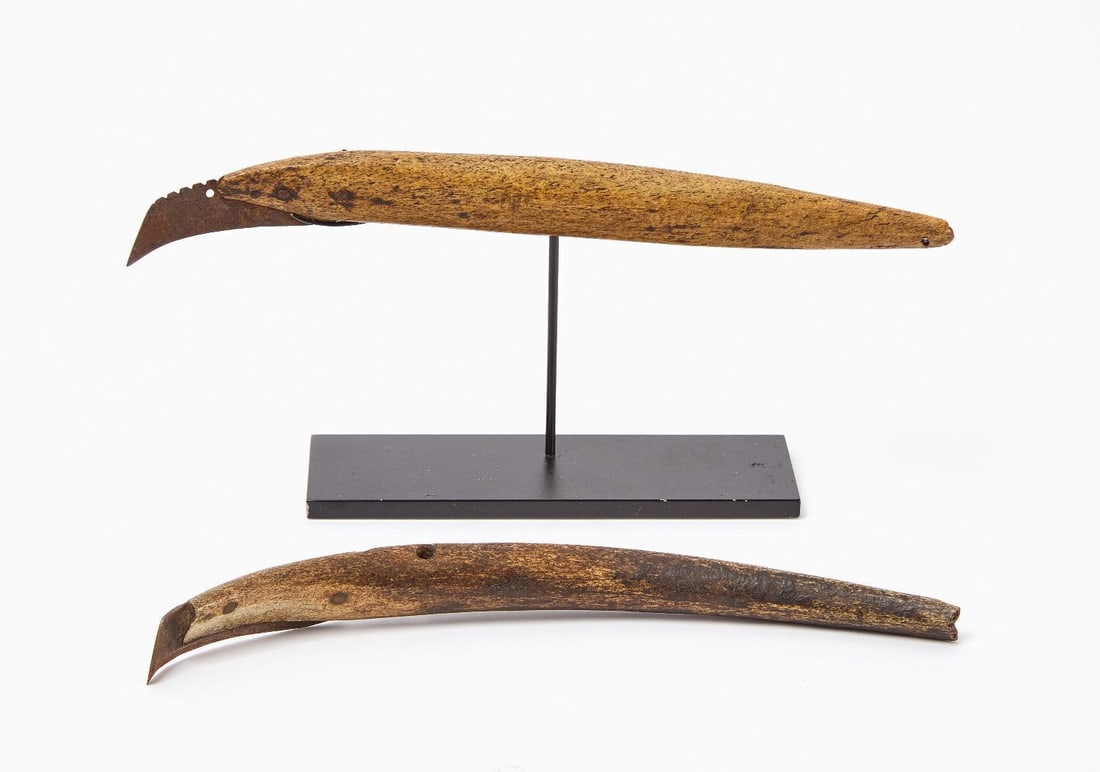 Pair of Eskimo Draw Knives: Pair of early Eskimo draw knives. Bone, re-worked steel blades, metal rivets. 19th century. Custom display stand included with one of the knives as shown. Provenance: Ex-Alan Siberberg (MA). Ea.