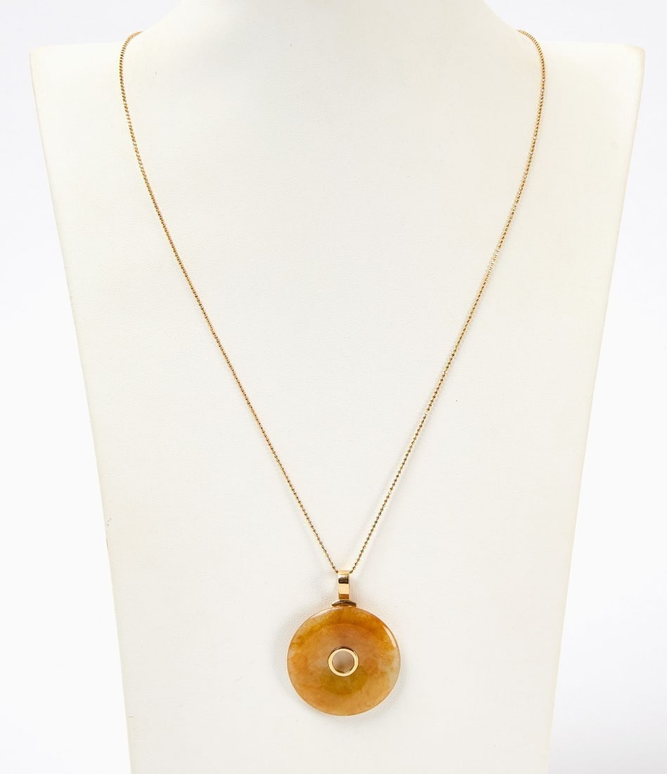 18K Gold and Honey Golden Jade Necklace: Carved Honey Golden Jade Pendant with 18K gold mounting and bail, suspended from 18K gold chain. Stamped 750 on chain, mounting and bail. Chain: 2.2 dwt Overall including jade: 7.8 dwt Total gross wei