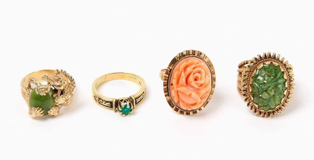 Four 14k Gold Rings: Four 14k gold rings. All stamped. One with emerald set in decorative engraved mount. Size: 6 Weight: 2.9 dwt. One with carved coral in oval mount, with rope-twist and openwork setting. Size: 6.5