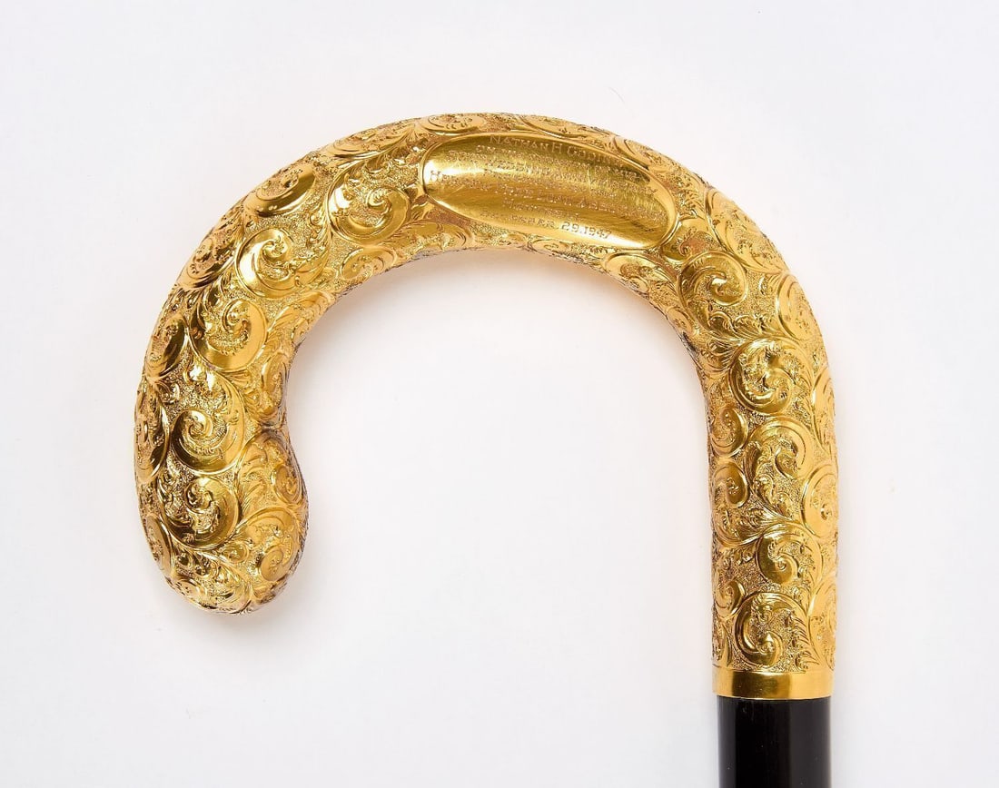Gold Presentation Cane for Hebrew Free Loan Association: Cane with rolled gold plate handle. Ebonized wood shaft. Presented as a 50th wedding anniversary gift from the Hebrew Free Loan Association. Montreal, Canada, 1947. L 36 in.