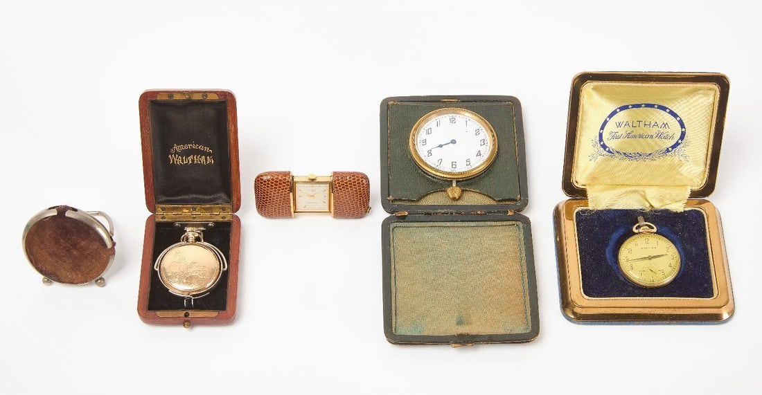Group of Early Time Pieces: Three early pocket watches, a folding desk clock, and an easel-back pocket watch case. 14k gold-filled Waltham in original presentation case, loose back and crystal. American Waltham in a