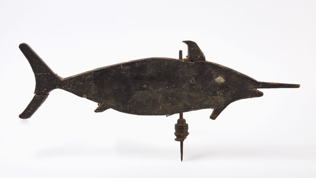 Carved Swordfish Weathervane: Carved Swordfish Weathervane. Black paint over carved wood with cast iron post. American, circa 1900. H 11-1/2 in. L 26-1/4 in.