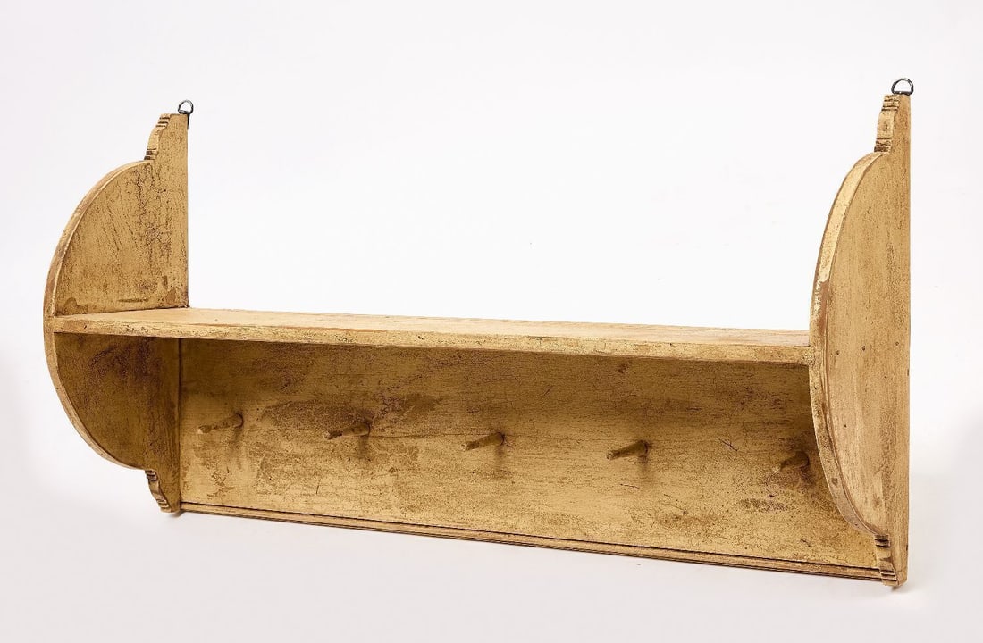 Hanging Shelf in White Paint: Hanging shelf and peg rack. Pine in original white paint. American, 19th century. H 21-1/2 in. W 41 in. D 10-1/8 in.