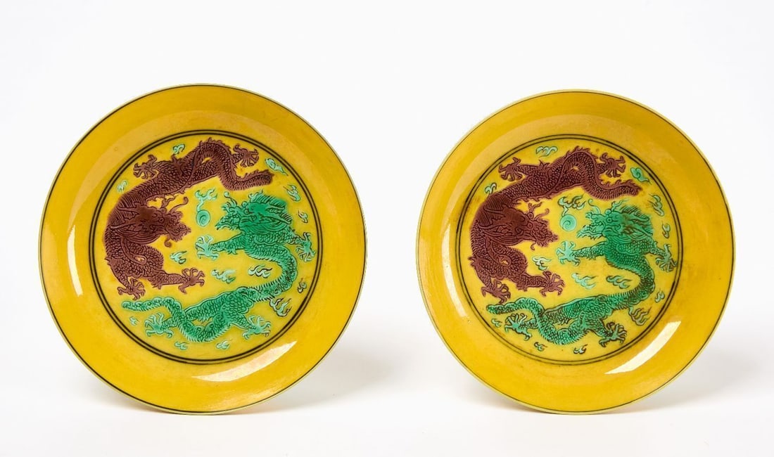 Pair of Small Famille Rose Dishes with Dragons: Pair of Famille Rose small plates with Dragons. Yellow-glazed porcelain featuring green and purple dragons design at the center, with cranes and clouds at the outer rim. Chinese, 18th century. Dia.