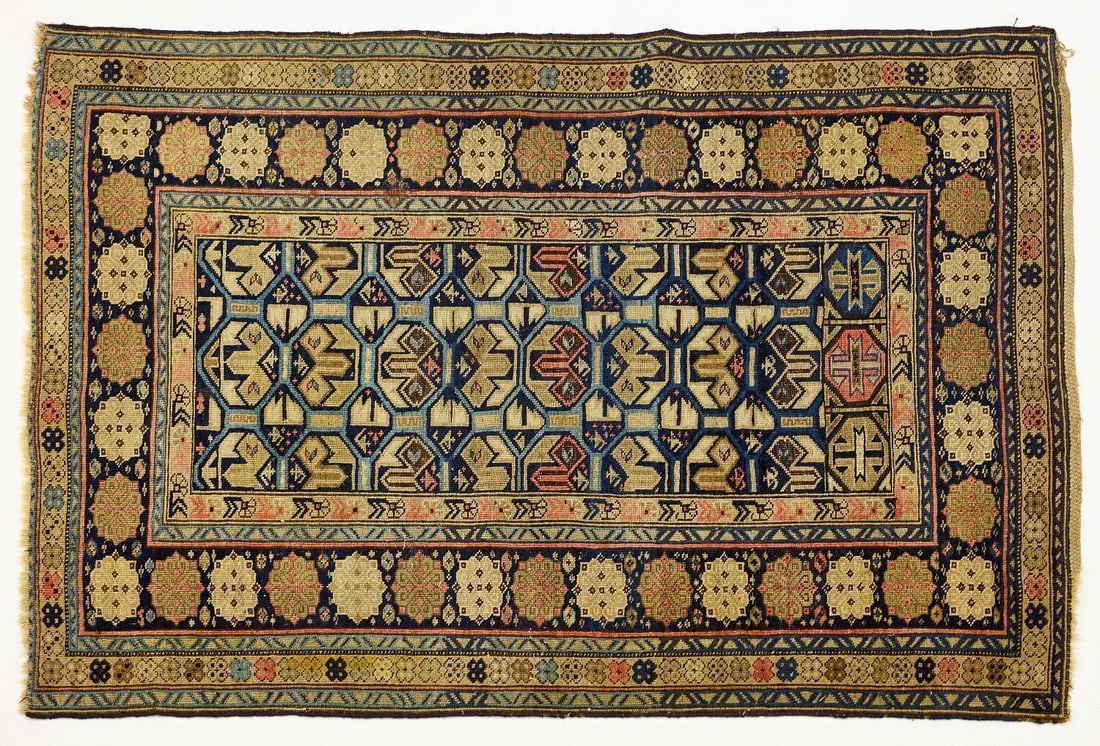Caucasian Shirvan Carpet: Caucasian Shirvan carpet. Hand-knotted wool with blue, beige and pink designs. Early 20th century. L 61 in. W (smaller edge) 40-3/4 in. W (wider edge) 43 in.