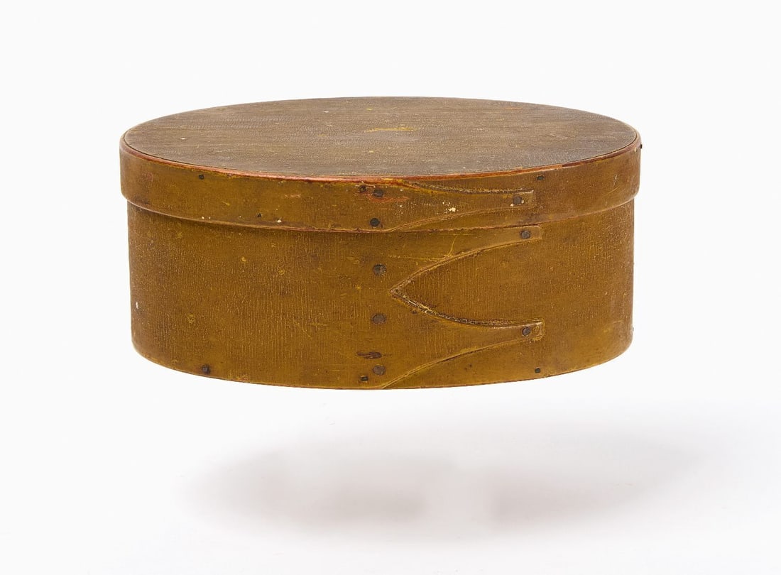 Shaker Box in Ochre Paint: Shaker 3-finger oval storage box in 19th century ochre over older chrome yellow paint. New England, mid 19th century. H 2-3/8 in. W 6 in. D 3-7/8 in.
