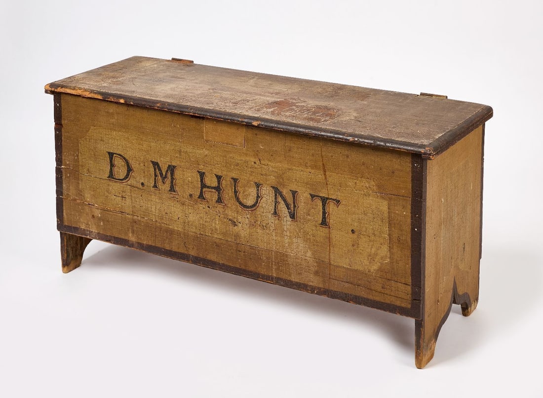 Paint Decorated Chest: Paint Decorated Chest with raised jackboot ends. Polychrome paint decoration with 'D.M. Hunt' painted on the front side. America, early 19th century. H 22-3/4 in. W (body) 45 in. D 17-1/4 in.&