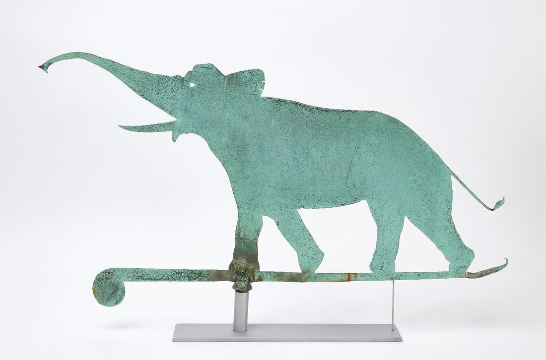 Elephant Weathervane: Elephant weathervane. Heavy sheet copper with a scrolled horizontal bar. Fine natural verdigris patina. American, late 19th century. Custom stand included as shown. H (on stand) 21-1/4 in. Weath