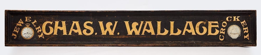 Jewelry and Crockery Trade Sign: 'Chas. W. Wallace. Jewelry. Crockery'. Single-sided wood board with gilt lettering on smaltz background. Original painted frame. Each end of the sign depicts a pocket watch and plate/teac