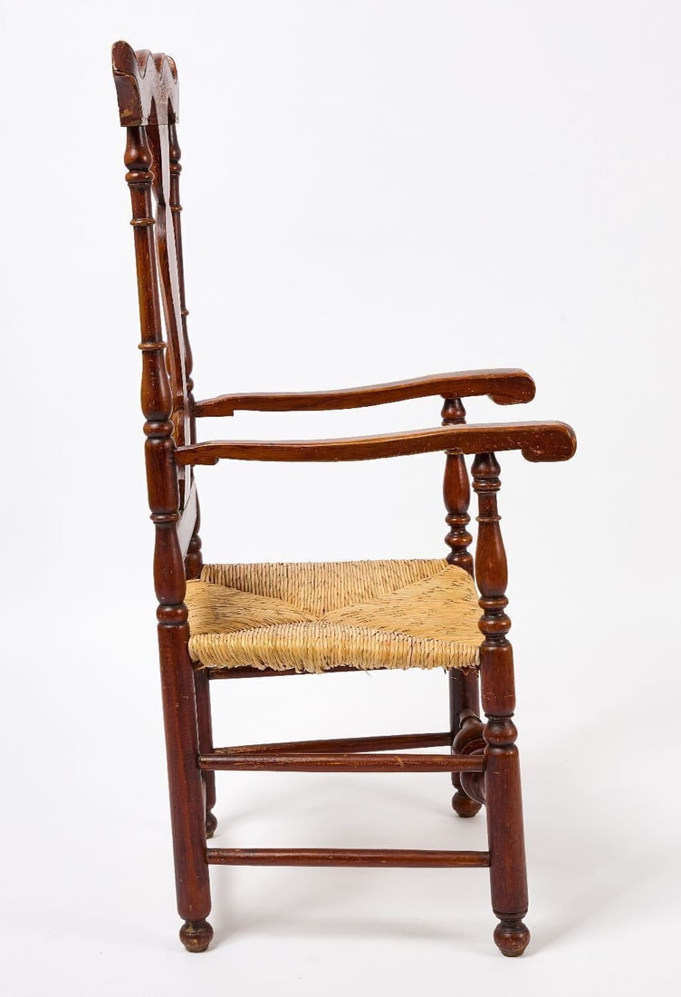 Transitional Queen Anne Arm Chair: Transitional Queen Anne arm chair. Exhuberant carved crest and turned medial stretcher. Old grain painted surface. American, circa 1750. H 46 in. W 21-1/2 in. D 21-1/4 in' SH 15-3/4 in.