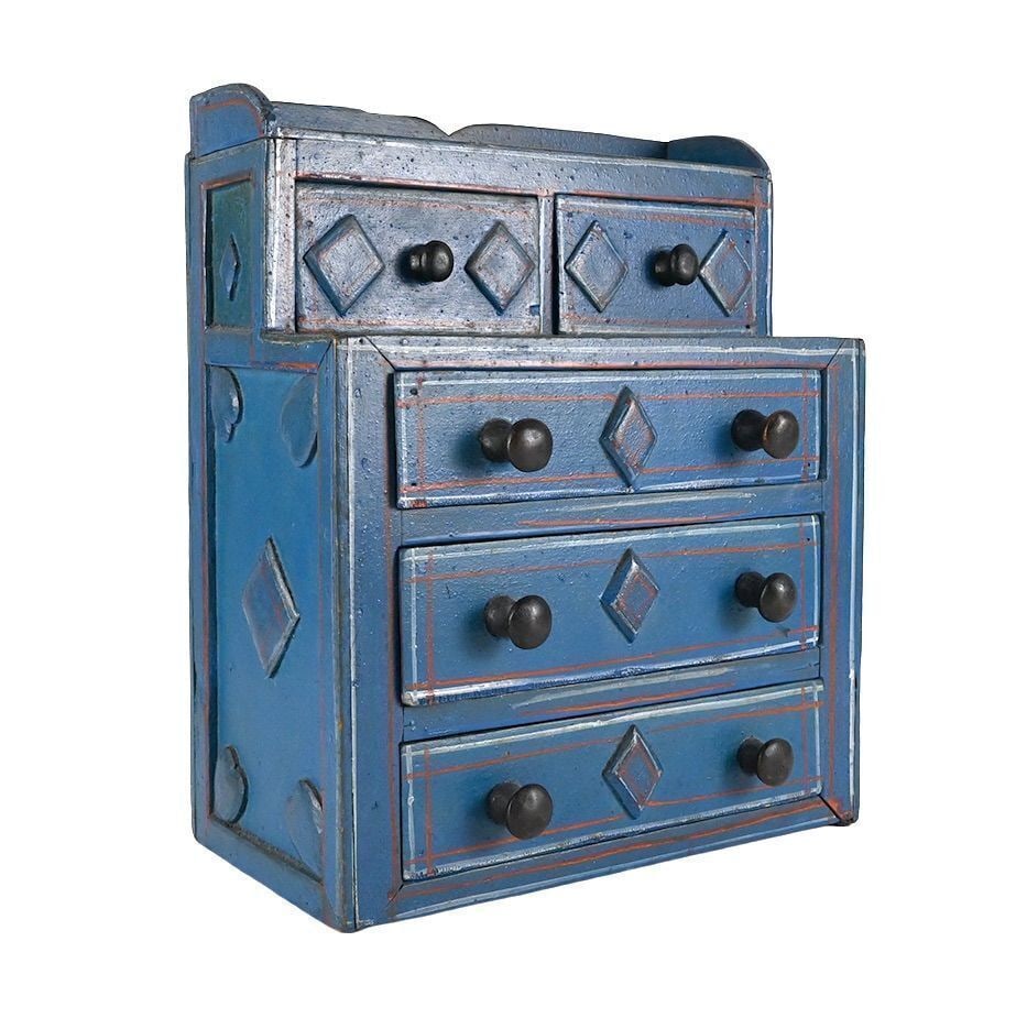 Spice Cabinet with Hearts and Diamonds: Spice cabinet with 5 drawers in old blue paint. Diamonds carved into drawer fronts and side of chest; heart to back. America, Circa 1895. Collection of Bob Snyder and Judy Wilson. H 11 in. W 9 in. D 4