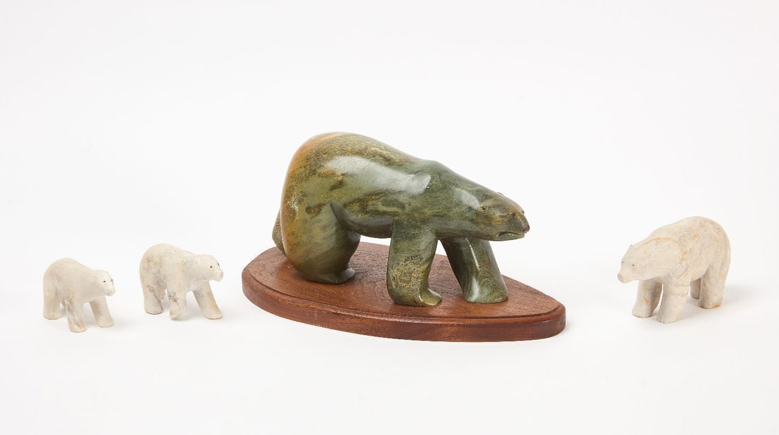 Four Inuit Stone Bears: Four bear figures. one carved stone polar bear sculpture on a wooden base and three white stone polar bear figurines. circa 1960s. H 6-1/2 in. L 12 in. H 3-1/4 in. L 5-1/2 in. H 2-1/2 in. L 4 in. H 2
