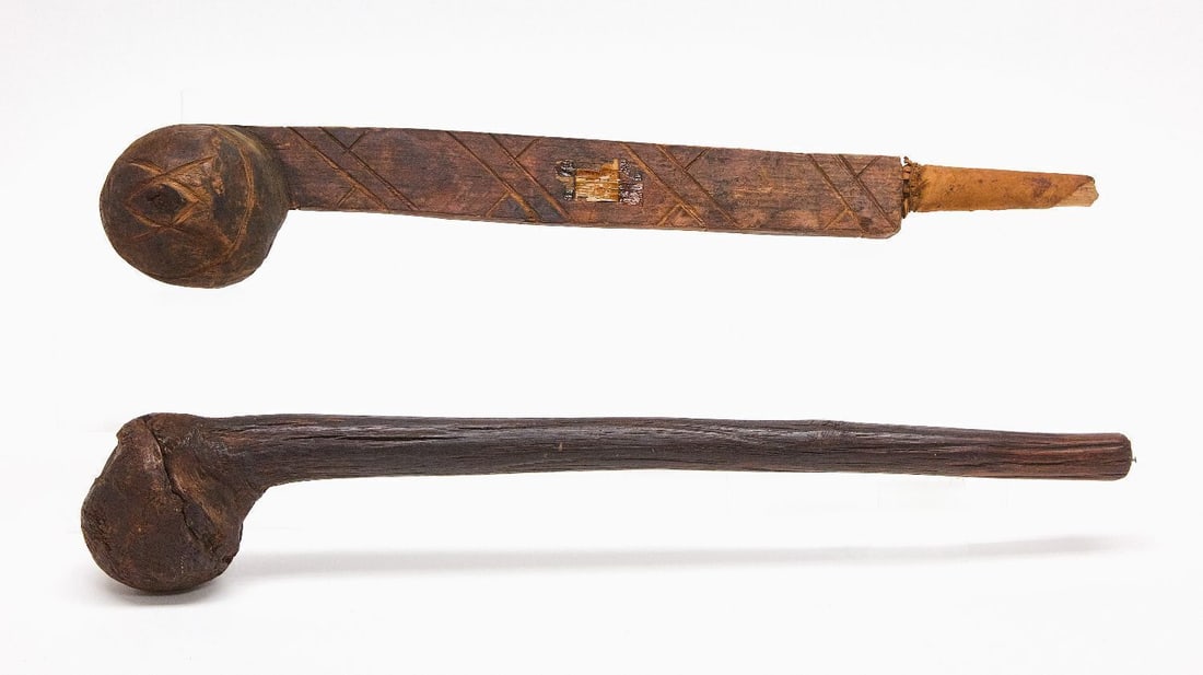 Two Plains War Clubs: Two Native American war clubs. Carved wood. One with incised decoration. Plains Region, 19th century. L 20-3/4 in. and L 21 in. 