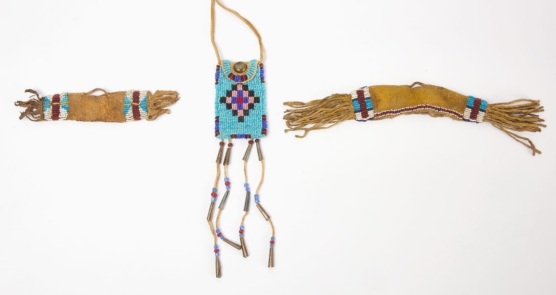 Beaded Pipe Bag and Two Scabbards: Native America beaded pipe bag and two beaded leather scabbards, early 20th century. Bag: L 18 -1/2 in. W 2 in. L 10-1/2 in. W 1-1/2 in. L 6 in. W 1-1/4 in.