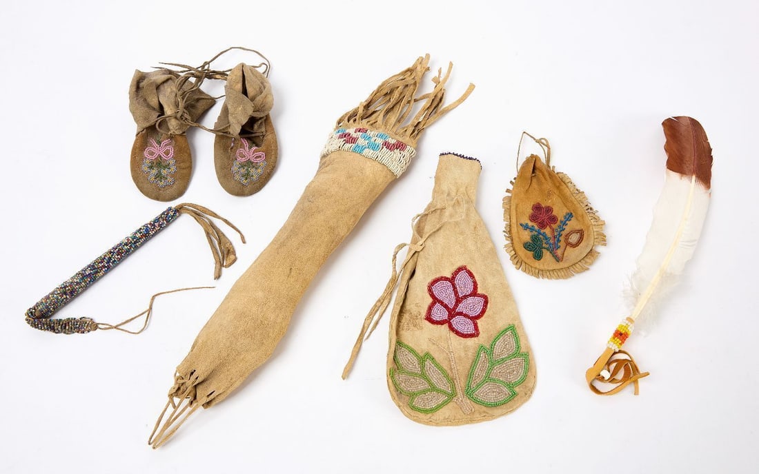 Group of Native American Beadwork: Group of Native American Beadwork. Inlcudes a pipe bag, two pouches with floral decoration, awl case, children's moccasins, and an adorned feather. Pipe Bag: L 19 in.