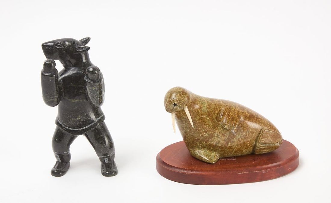 Two Soapstone Sculptures: Two carved stone sculptures shamanic figure and naleniktemela temela on a wooden base. Canadian Arctic, such as Kimmirut ( formerly Lake Harbour) Late 20th century. H 8 in. H 5 in. W 8-1/2 in.