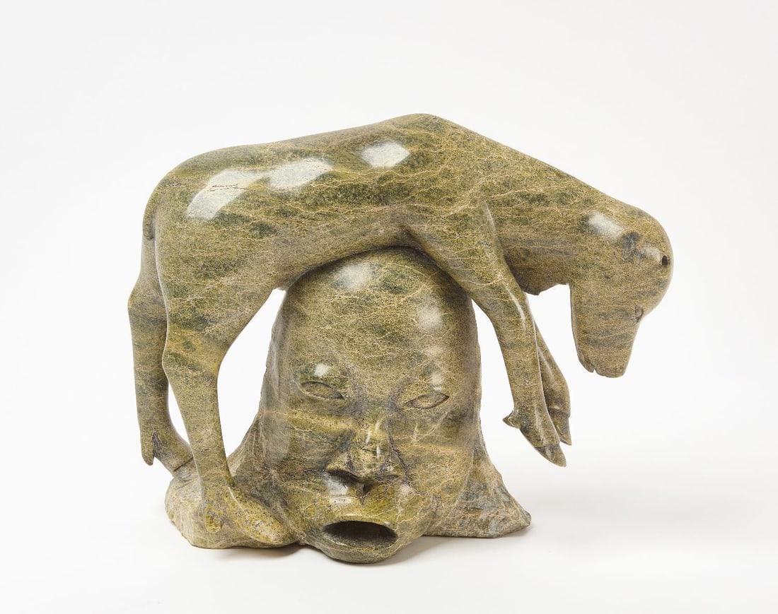 Josephee Kakee Transformation Carving: Josephee Kakee ( 1911-1977 ) deer on head in olive, tan and forest green variegated stone, H 10 in. W 12 in.
