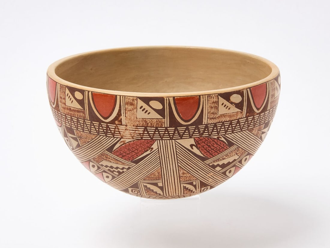Beth Sakeva Hopi Bowl: Beth Sakeva (1926-1994), Hopi bowl with sherd design. The composition is layered with stylized bird elements, migration motifs, and fine linework, all rendered in deep brown and red against a