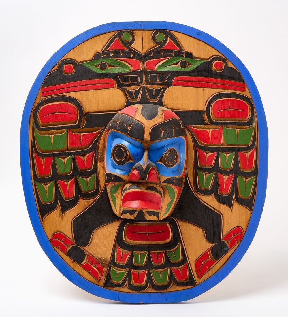 Northwest Coast Carved Mask Sculpture: Northwest Coast Carved Mask. Cedar plaque with polchrome paint in red, blue, black, and green. Plaque centering a projecting mask in relief. Native American, Northwestern Region, early 20th