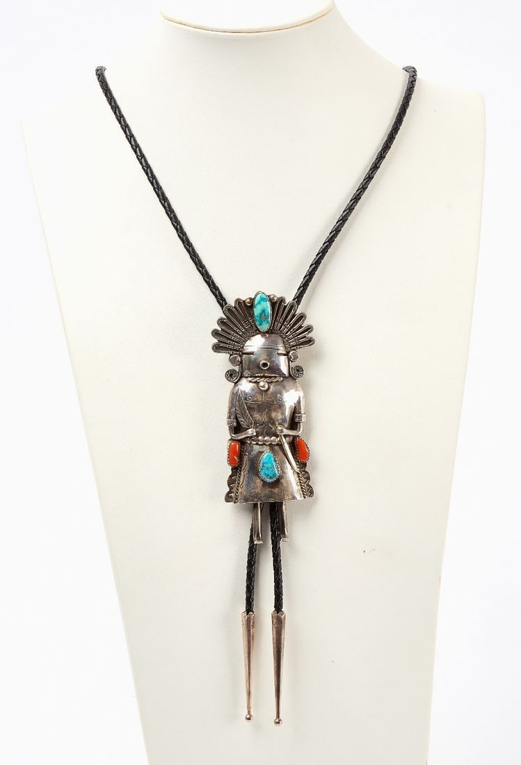 Sterling Kachina Bolo Tie: Sterling silver kachina bolo tie with inset turquoise and red coral. L 19 in. Kachina: L 3-3/4 in. Total Weight: 1.8 ozt.
