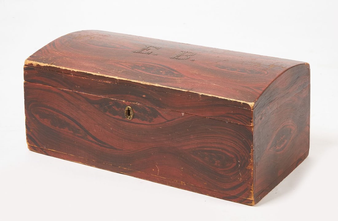 Paint-Decorated Dome Top Trunk, initialed 'EB': Paint-decorated dome top trunk in black and red. Nails spell the initials 'EB' on the lid. American, mid 19th century. H 11 in. W 27 in. D 13-1/2 in.