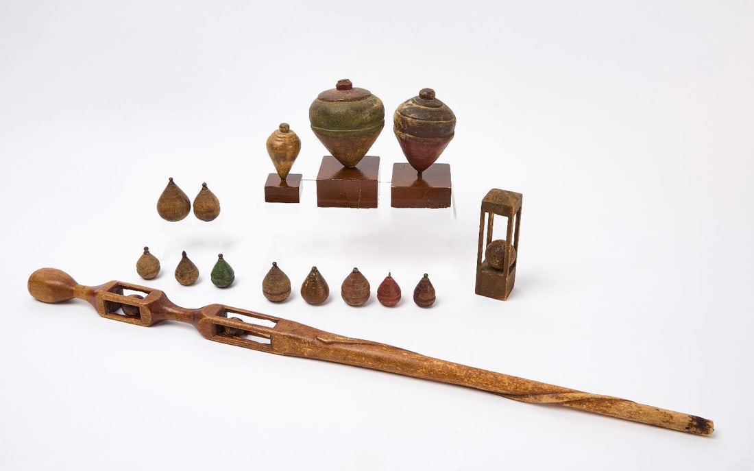 Group of Folk Art Whimsies: Group of folk art carved and painted whimsies. Including a carved walking stick, ball and cage whimsey and a group of turned and painted wood tops. American, circa 1900. Walking stick: L 34 in,