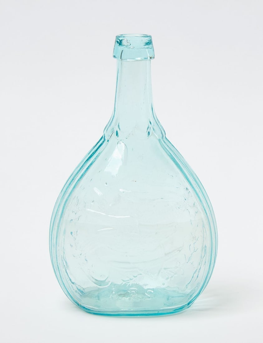 Masonic Flask: Masonic flask of embossed glass with pontil base. Light blue with clasped hands, 'union' below, the masonic compass and square. Reverse side depicts bird with shield and the initials