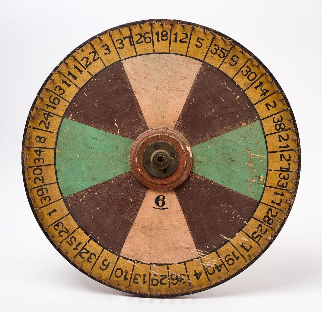 Carnival Wheel Gameboard: Carnival wheel game board with numbering. Original paint on wood panel. American, Circa 1930. D 24 in. Collection of Bruce and Doranna Wendel.