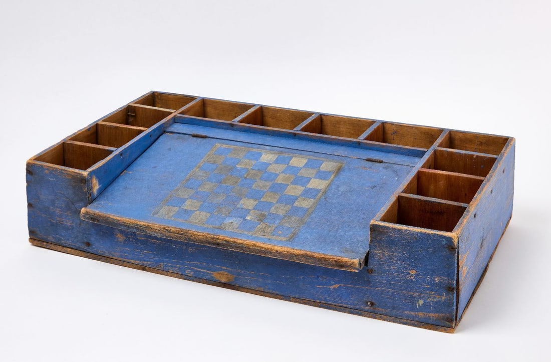 Painted Compartment Box with Checkers: Wooden compartment box in blue paint with checkers game board. Original paint. American, Early to Mid -20th Century. H 16 in. W 26 in. Collection of Bruce and Doranna Wendel.