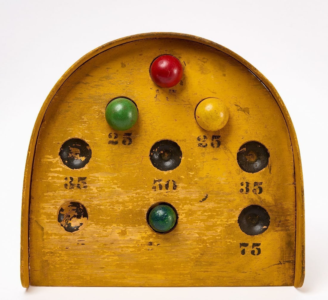Skee-Ball Game: Skee-Ball style rolling game Game with numbered scoring holes. Original paint on wood panel. American, Circa 1920s - 1930s. H 13 in. W 14-1/4 in. Collection of Bruce and Doranna Wendel.