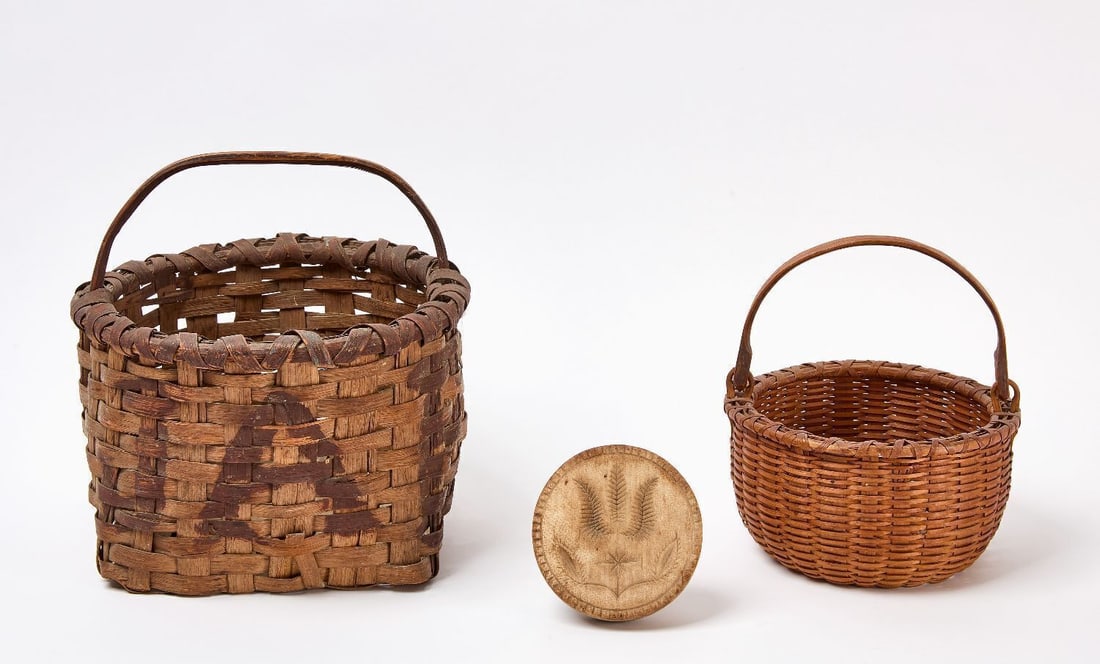 Two Baskets and Butter Stamp: Two antique baskets (one with swing handle). Together with a butter stamp. American, late 19th century. Baskets (handles up): H 11-1/4 in. D 11-1/4 in., and H 9-1/4 in. D 8-1/4 in. Stamp: L 4-5/8 in.