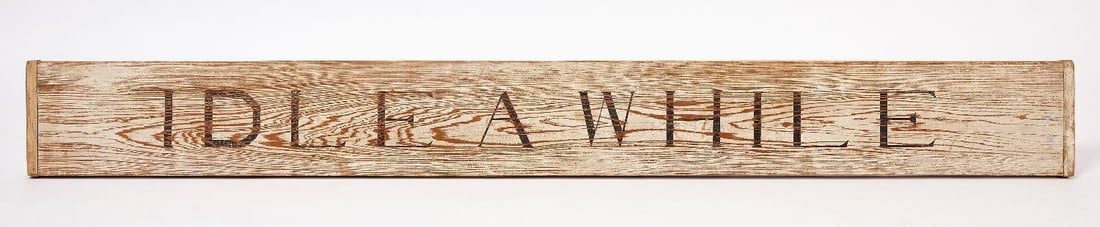 Idle A While Sign: Single-sided sign reading 'Idle A While'. Paint on wood board. American, likely contemporary. H 8 in. L 73-1/4 in. 