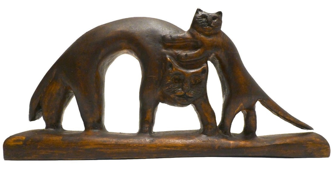Folk Art Carved Cat and Kitten: Folk art carving of a cat and kitten. Larger cat shown with exaggerated arched body. Appears to have been carved from a single piece of wood. Stamped by carver on underside (partially