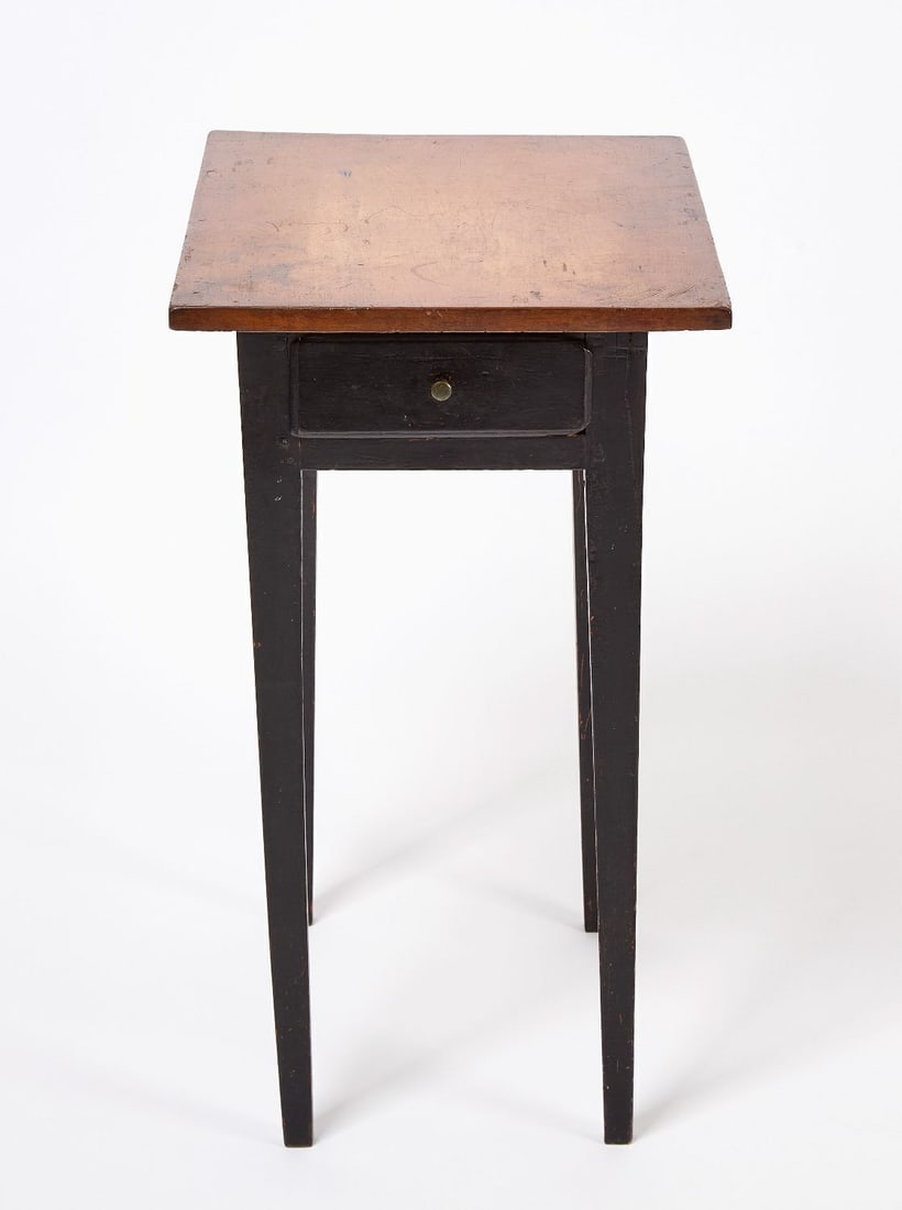 One Drawer Stand: One drawer stand. Base in old black paint. Tapered legs. Peg and mortise construction. American, circa 1830. H 26-3/8 in. W 15-3/8 in. D 21-1/2 in. 