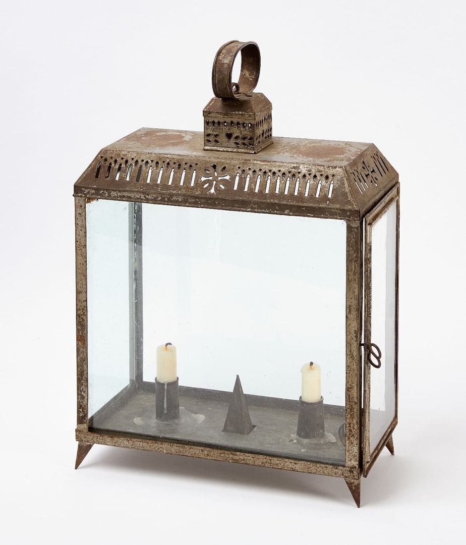 Double Candle Lantern: Double candle lantern. Pierced tin with glass panels. Side-loading door. Resting on pointed conical feet. American, 19th century. H 16-3/4 in. W 11-3/4 in. D 5-3/4 in.