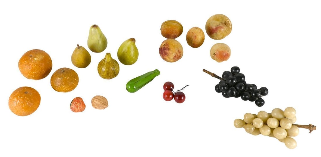 Collection of Stone Fruit: Collection of carved stone fruit, eighteen pieces total. Comprising oranges, pears, figs, a pepper, plums, cherries, a strawberry, a walnut, and two bunches of grapes (one black, one white).