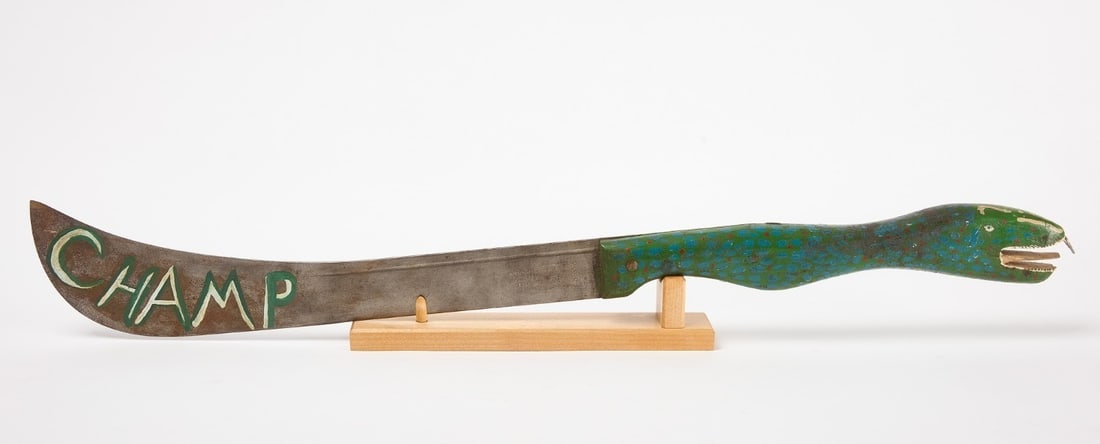 Folk Art Lake Monster Machete: Folk art fighting sword / machete with carved and painted wood serpent handle. Made to resemble the fictional lake monster 'Champ', who purportedly lives within the depths of Lake