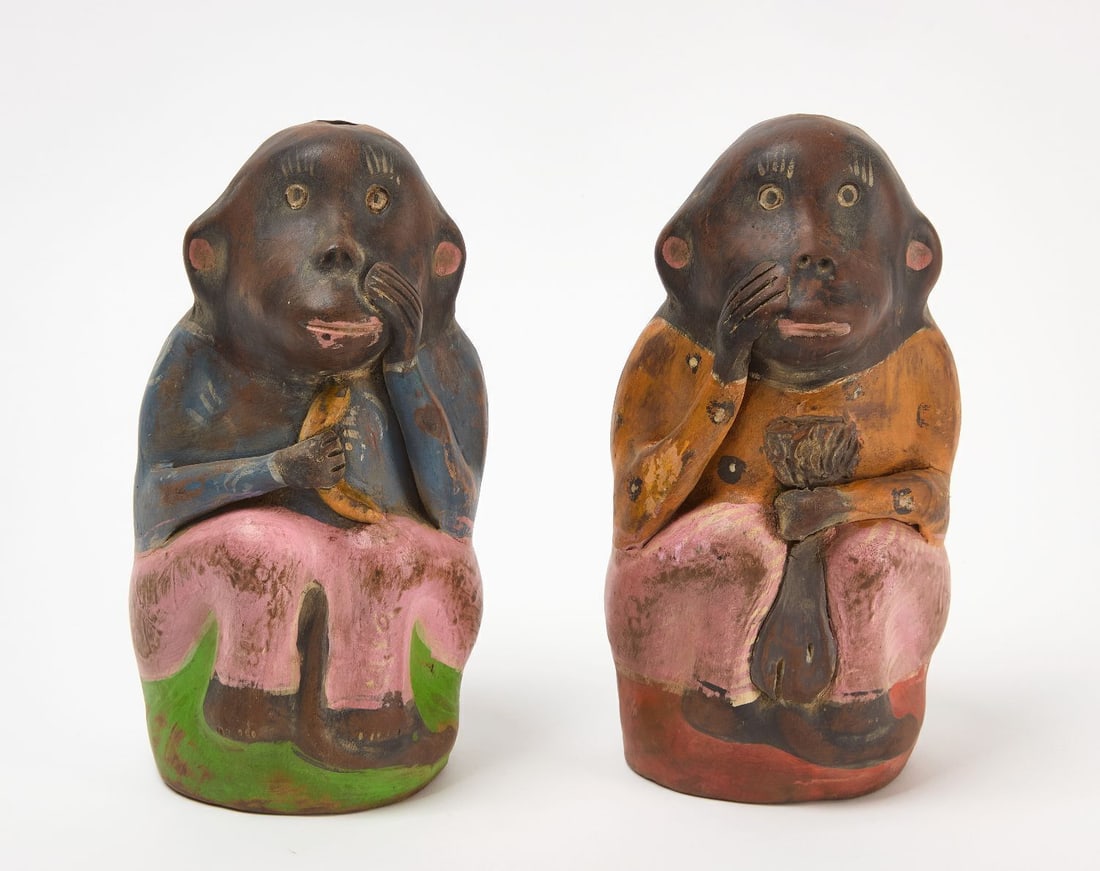 Pair of Painted Pottery Monkey Mezcal Bottles: Pair of painted pottery monkey mezcal bottles. Ea approx: H 9-1/4 in. W 4-3/4 in. D 4-5/8 in.